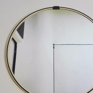 A circular original black and white mirror