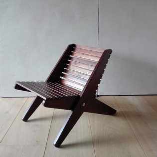 A solid wood folding armchair