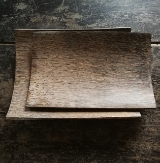 Unusual set of two plain wood platters on a small square base