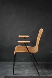 A Dutch black metal and rotan armchair