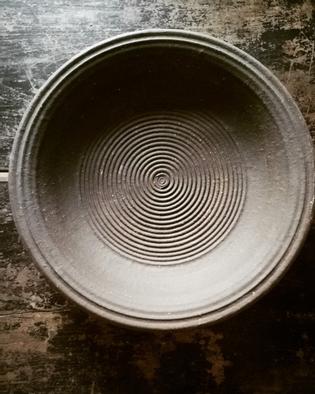 A large black and brown stoneware bowl