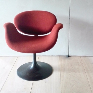 A Pierre Paulin tulip chair, orange fabric, black metal disc