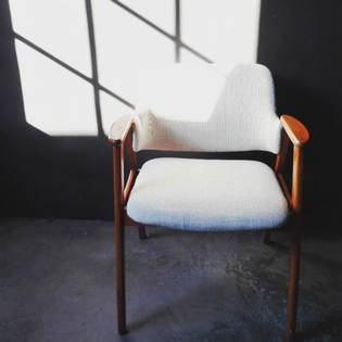 A scandinavian armchair with linnen covering