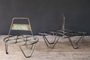 A set of iron cast holders for small vases