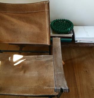 a suede and black metal safari chair
